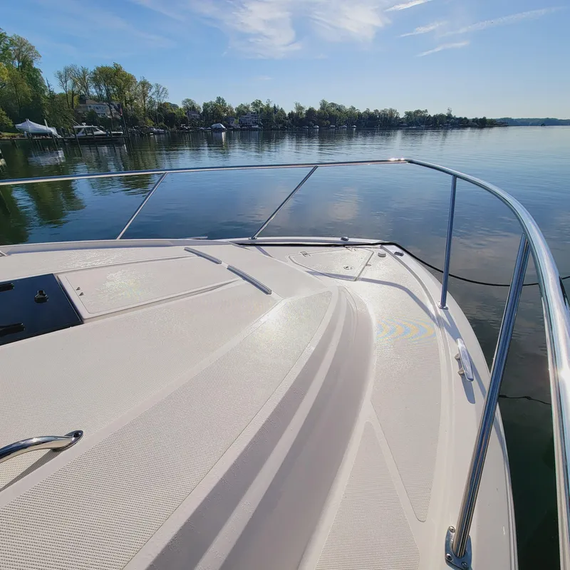 Slide: The Image of 2023 Pursuit OS 325 Offshore boat deck with scenic lake view. - 10
