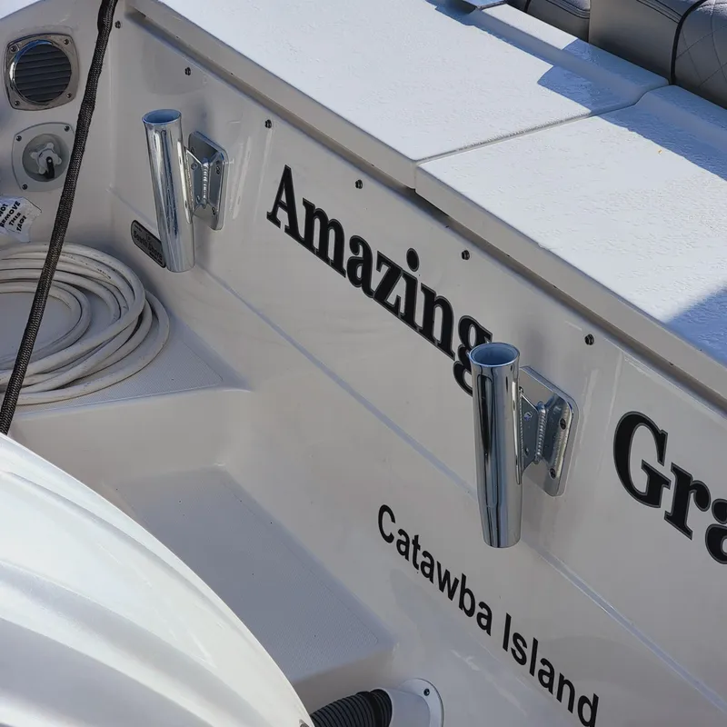 Slide: The Image of 2023 Pursuit OS 325 Offshore boat with "Amazing Grace" name, docked at Catawba Island. - 14