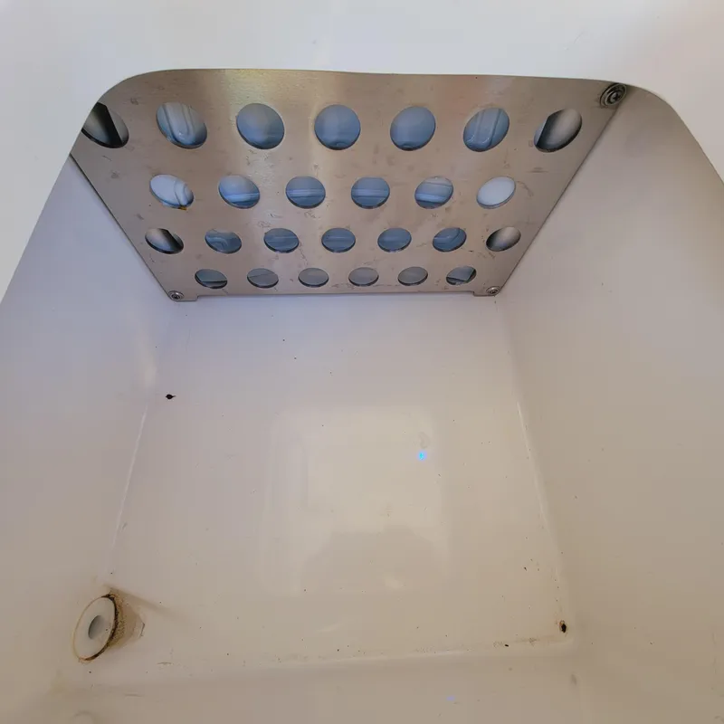 Slide: The Image of 2023 Pursuit OS 325 Offshore boat compartment with perforated metal panel. - 22