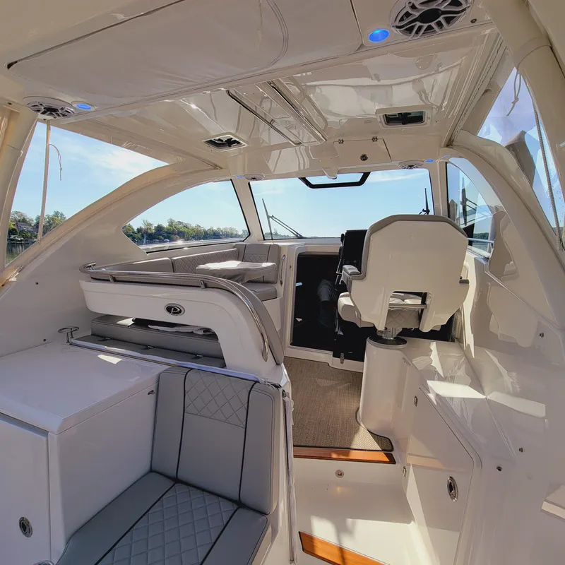 Slide: The Image of 2023 Pursuit OS 325 Offshore boat interior with modern seating and helm station. - 23