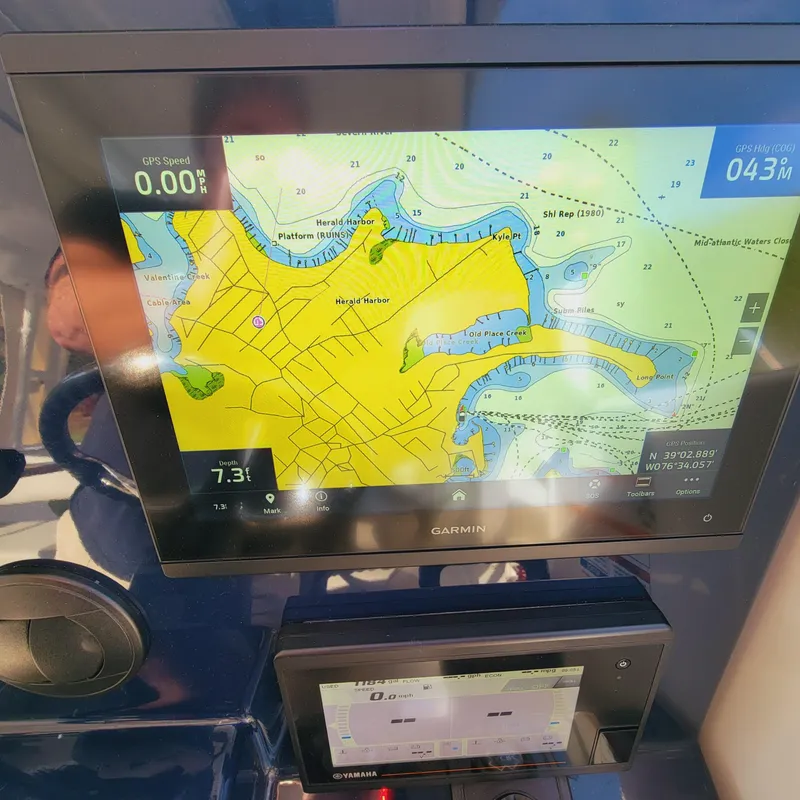 Slide: The Image of Garmin navigation display on 2023 Pursuit OS 325 Offshore boat, showing detailed marine map. - 29