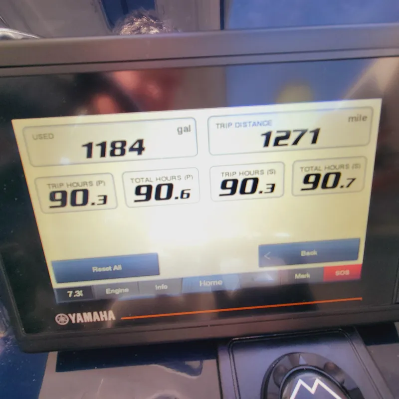 Slide: The Image of Yamaha display showing fuel usage, trip distance, and engine hours on a 2023 Pursuit OS 325 Offshore. - 32