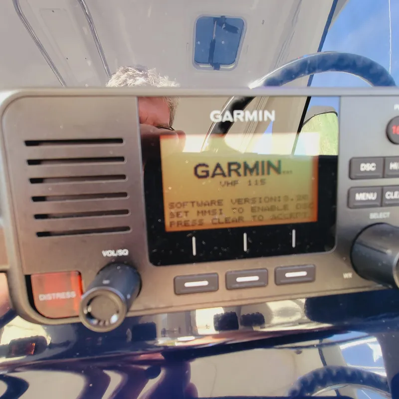 Slide: The Image of Garmin VHF 115 radio on 2023 Pursuit OS 325 Offshore boat dashboard. - 33