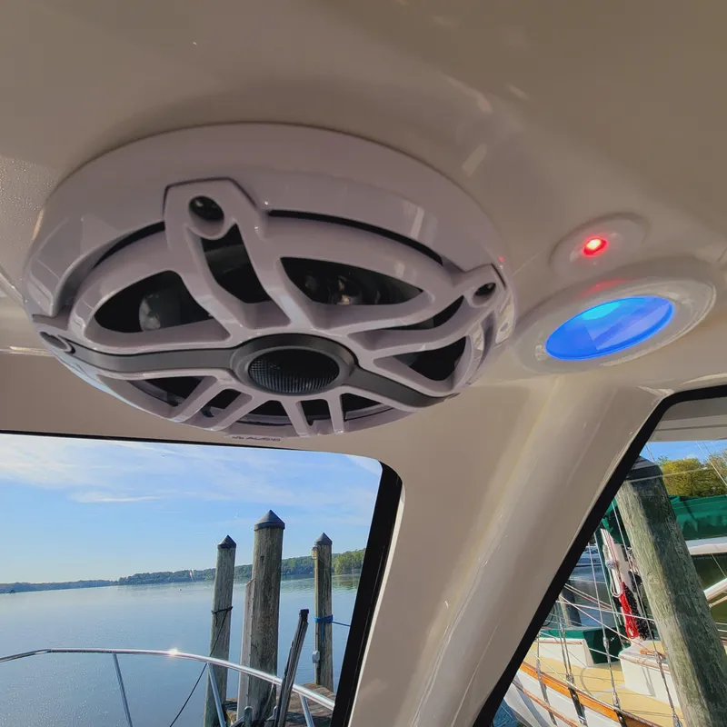 Slide: The Image of Ceiling speaker and lights inside 2023 Pursuit OS 325 Offshore boat cabin. - 36