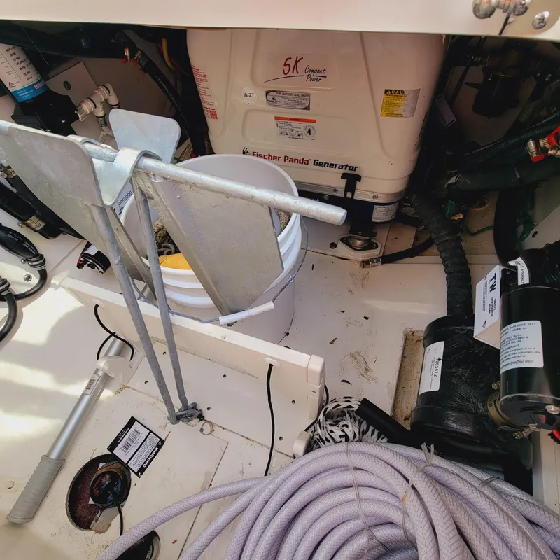 Slide: The Image of 2023 Pursuit OS 325 Offshore boat interior with generator and anchor equipment. - 49