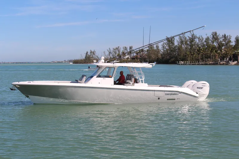 The Image of 2024 Everglades 395 Center Console boat cruising on clear blue water. - 0