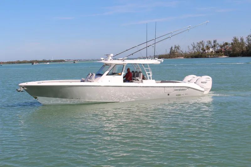 Slide: The Image of 2024 Everglades 395 Center Console boat cruising on calm water. - 1