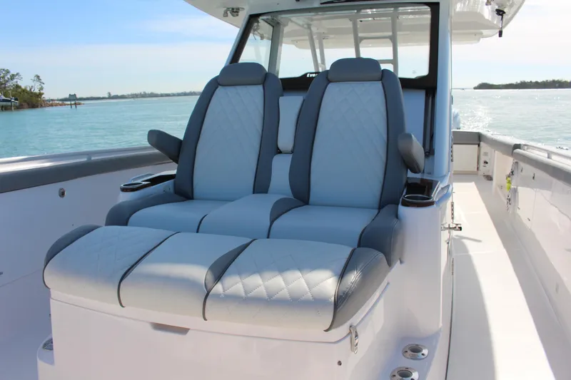 Slide: The Image of 2024 Everglades 395 Center Console boat with Garmin equipment, docked under clear blue sky. - 11