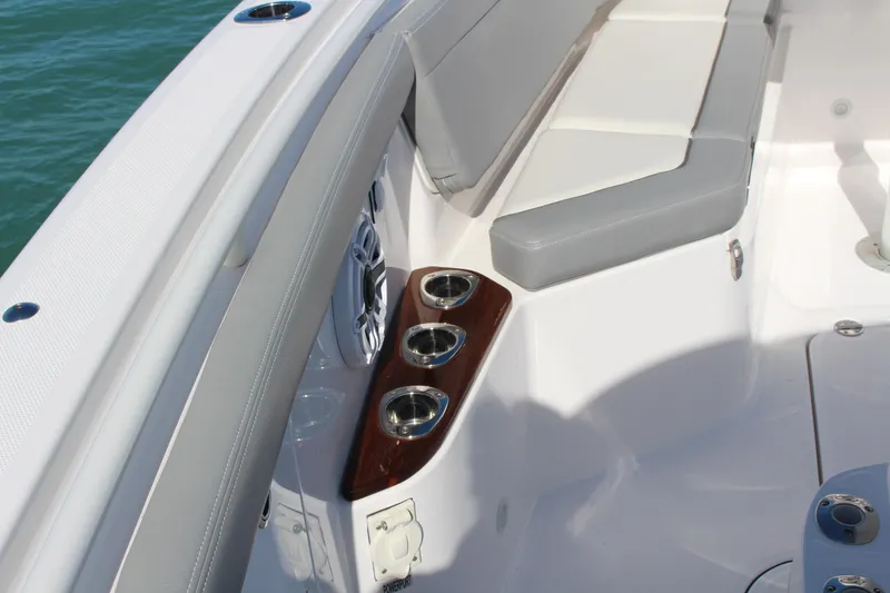 Slide: The Image of 2024 Everglades 395 Center Console boat with spacious seating and table on calm water. - 13