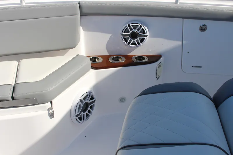 Slide: The Image of 2024 Everglades 395 Center Console boat interior with cushioned seating and table. - 17