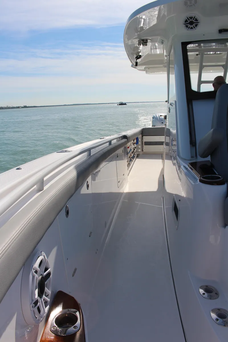Slide: The Image of 2024 Everglades 395 Center Console boat with spacious seating and cup holders. - 19