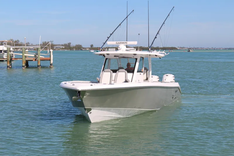 Slide: The Image of 2024 Everglades 395 Center Console boat cruising on calm water. - 2
