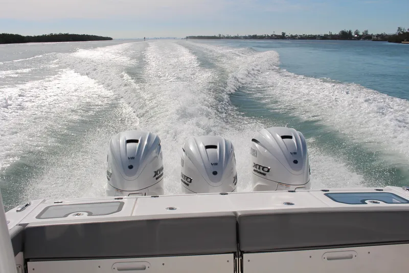 Slide: The Image of 2024 Everglades 395 Center Console boat cruising on calm waters. - 3