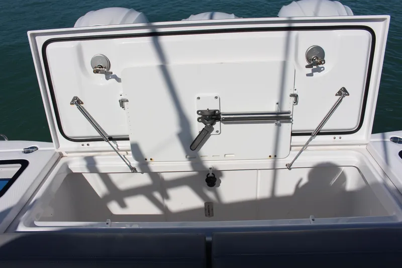 Slide: The Image of 2024 Everglades 395 Center Console boat with open storage compartment and speaker. - 33