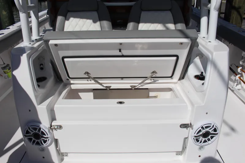 Slide: The Image of 2024 Everglades 395 Center Console storage compartment with open lid, showcasing interior space. - 35