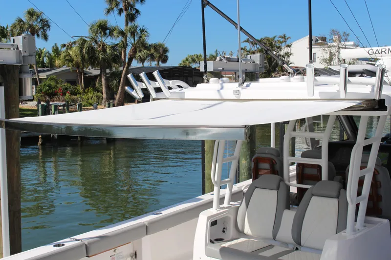 Slide: The Image of 2024 Everglades 395 Center Console boat against clear blue sky. - 38