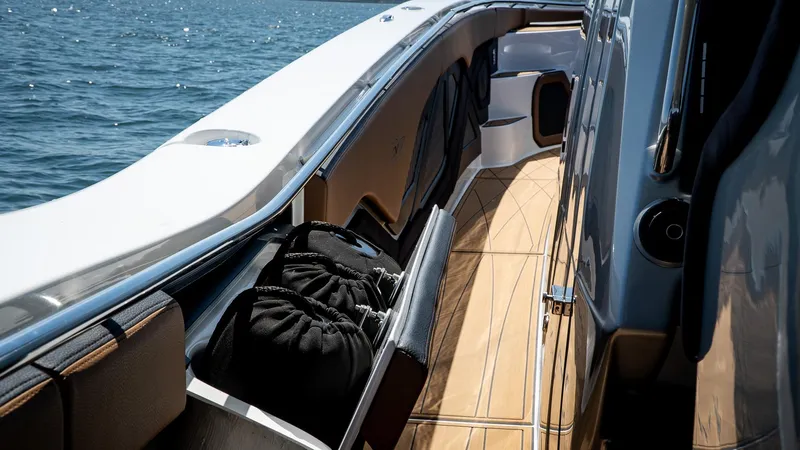 Slide: The Image of Luxury MTI V50 yacht deck with sleek design, 2022 model, cruising on open water. - 12
