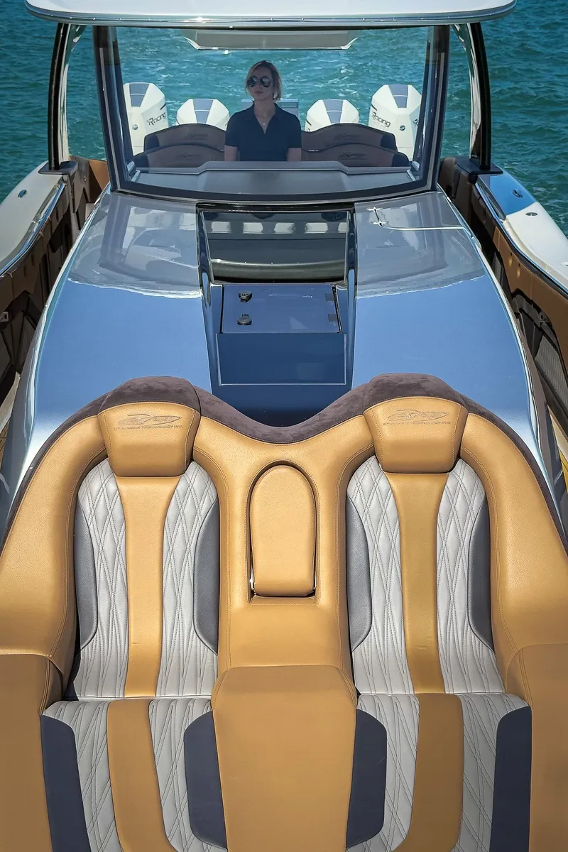 Slide: The Image of Luxury MTI V50 boat interior with tan and gray seating, 2022 model on water. - 15