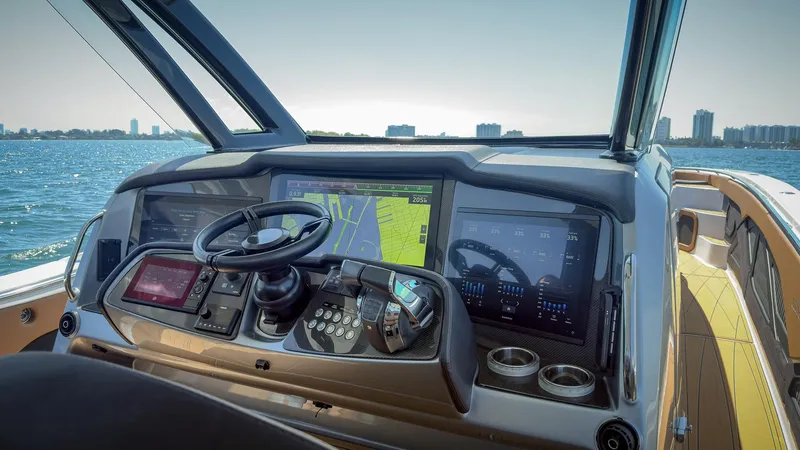 Slide: The Image of Modern MTI V50 boat dashboard with navigation screens, steering wheel, and controls, 2022 model. - 18