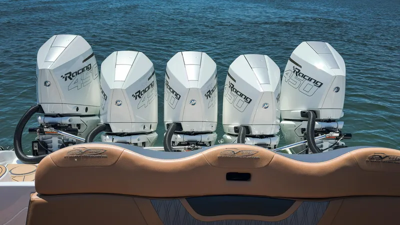 Slide: The Image of Five powerful outboard motors on an MTI V50 boat, 2022 model, in the water. - 23