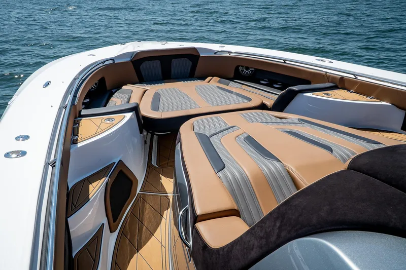 Slide: The Image of Luxury MTI V50 boat interior with tan and gray seating, 2022 model, on open water. - 28
