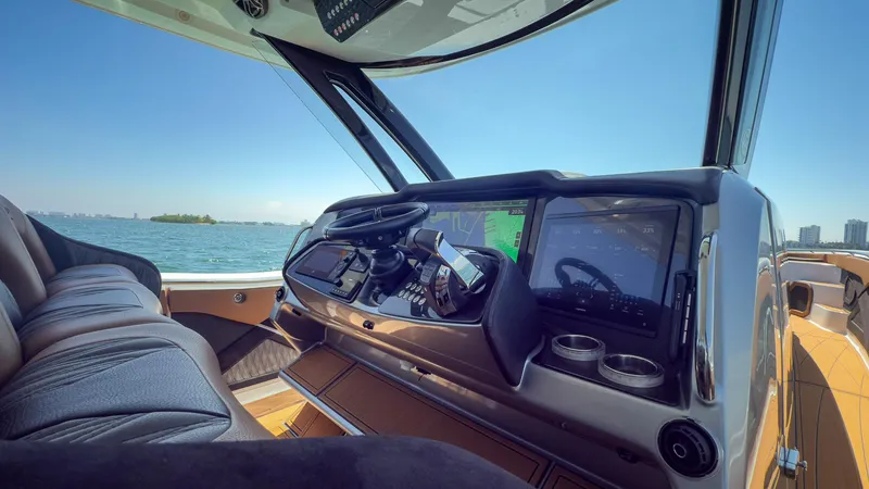 Slide: The Image of Interior view of 2022 MTI V50 boat cockpit with modern controls and ocean backdrop. - 29