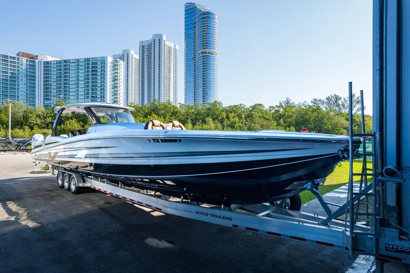 Slide: The Image of 2022 MTI V50 boat on trailer with city skyline in background. - 3