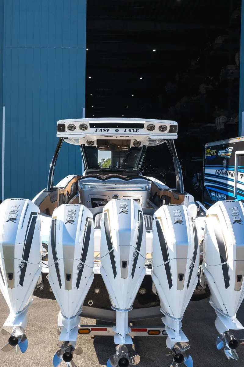 Slide: The Image of 2022 MTI V50 boat with four powerful outboard engines in a marina setting. - 37