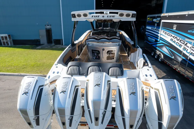 Slide: The Image of High-performance MTI V50 boat with quad 450R engines, 2022 model, docked near a trailer. - 41