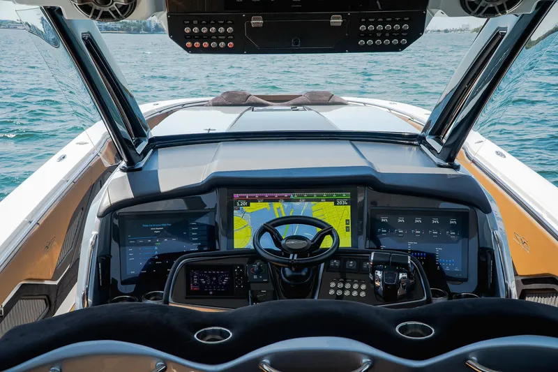 Slide: The Image of Cockpit of 2022 MTI V50 boat with advanced navigation screens and controls on open water. - 47