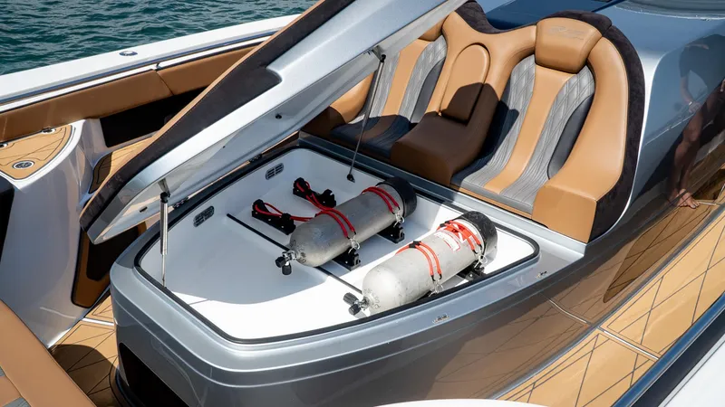 Slide: The Image of 2022 MTI V50 boat with open storage compartment and luxury seating. - 49