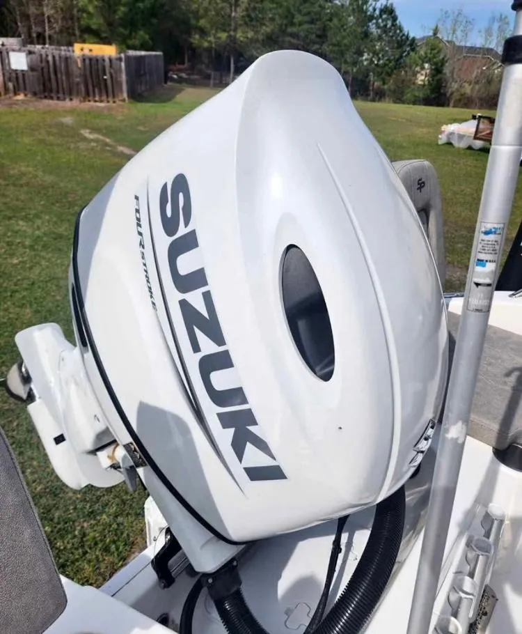 Slide: The Image of 2022 Sea Pro 199 Deep V Center Console with Suzuki outboard motor in grassy area. - 5