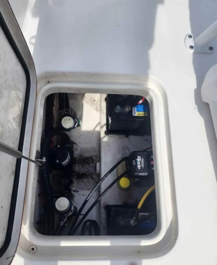 Slide: The Image of 2022 Sea Pro 199 Deep V Center Console battery compartment with wiring and components. - 9