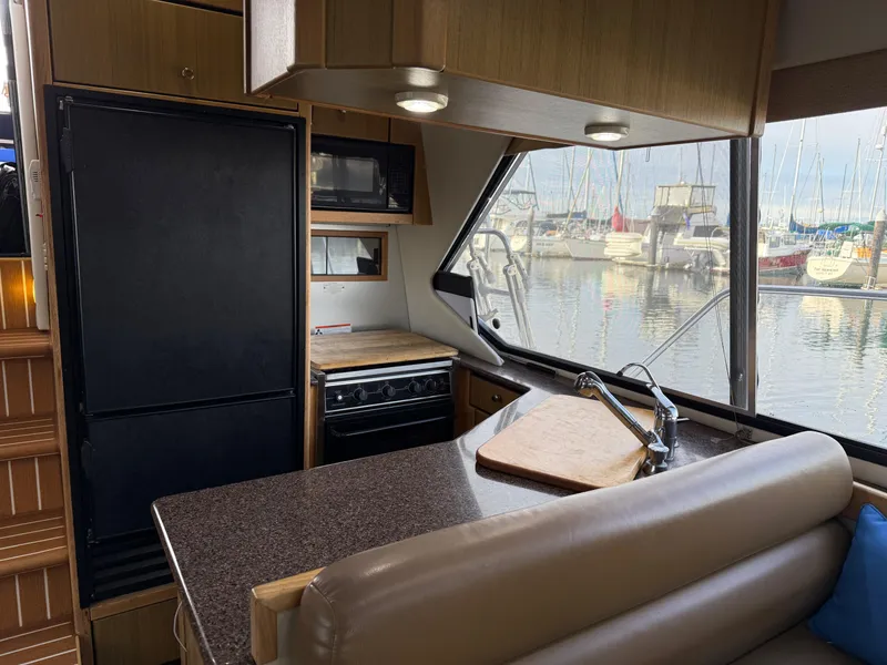 Slide: The Image of Interior of 2002 Bayliner 4087 Aft Cabin Motoryacht with kitchen and marina view. - 11