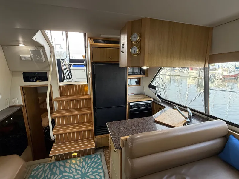 Slide: The Image of Interior of 2002 Bayliner 4087 Aft Cabin Motoryacht with kitchen and seating area. - 12