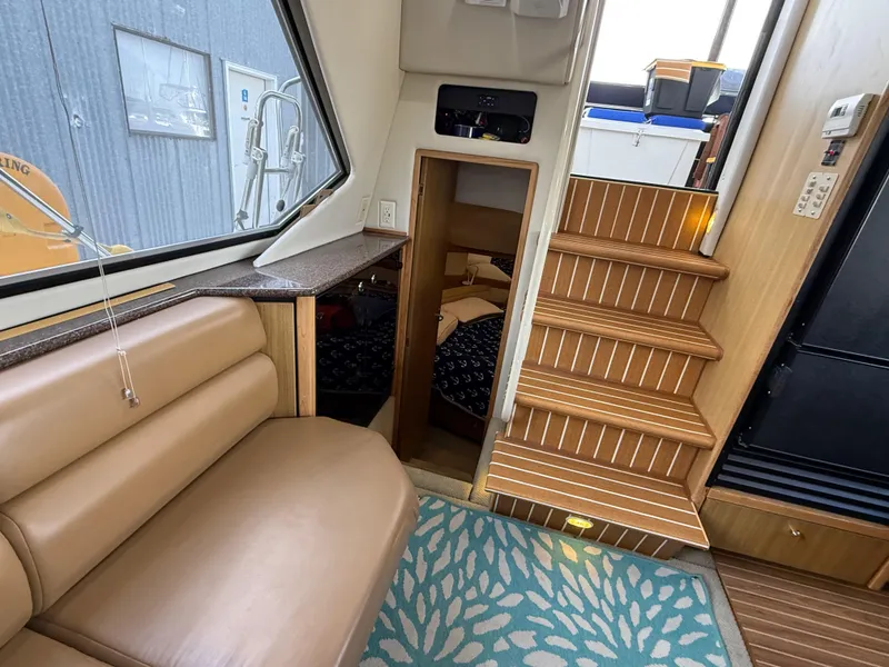 Slide: The Image of Interior of 2002 Bayliner 4087 Aft Cabin Motoryacht with seating, stairs, and cabin entrance. - 14