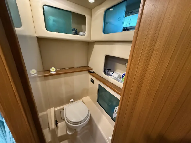 Slide: The Image of 2002 Bayliner 4087 Aft Cabin Motoryacht bathroom with storage shelves and modern fixtures. - 20