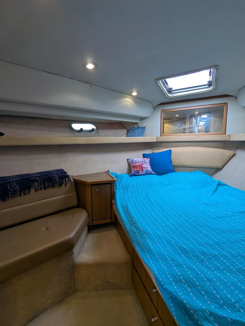 Slide: The Image of 2002 Bayliner 4087 Aft Cabin Motoryacht interior with cozy bed and seating area. - 23