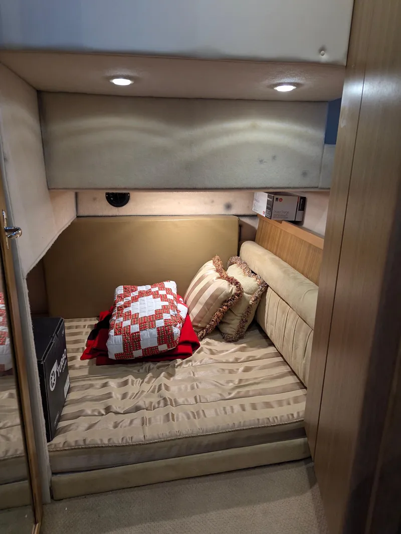 Slide: The Image of 2002 Bayliner 4087 Aft Cabin Motoryacht interior with cozy bedding and ambient lighting. - 24