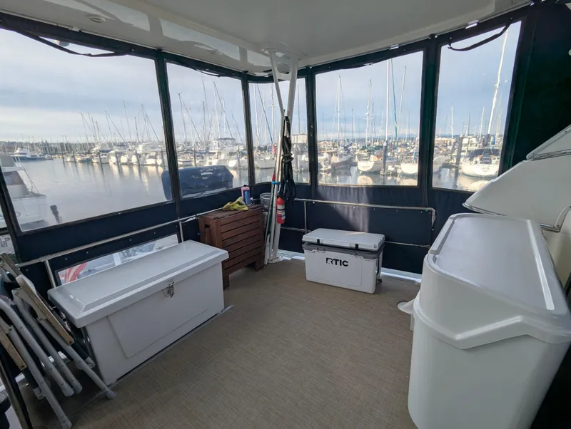 Slide: The Image of Bayliner 4087 Aft Cabin Motoryacht 2002 interior with marina view and storage boxes. - 28