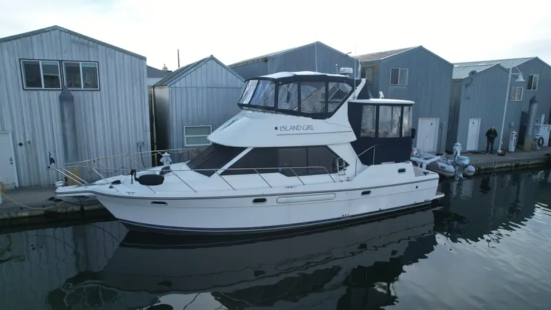 Slide: The Image of 2002 Bayliner 4087 Aft Cabin Motoryacht docked beside waterfront buildings. - 31
