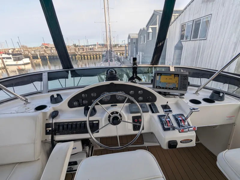 Slide: The Image of 2002 Bayliner 4087 Aft Cabin Motoryacht helm with steering wheel and navigation equipment. - 33