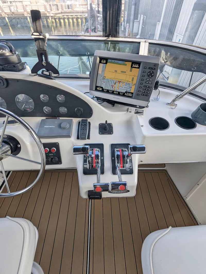 Slide: The Image of 2002 Bayliner 4087 Aft Cabin Motoryacht helm with navigation system and controls. - 34