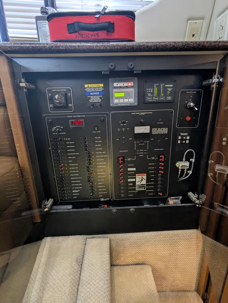 Slide: The Image of Electrical panel inside 2002 Bayliner 4087 Aft Cabin Motoryacht, featuring control switches and indicators. - 43