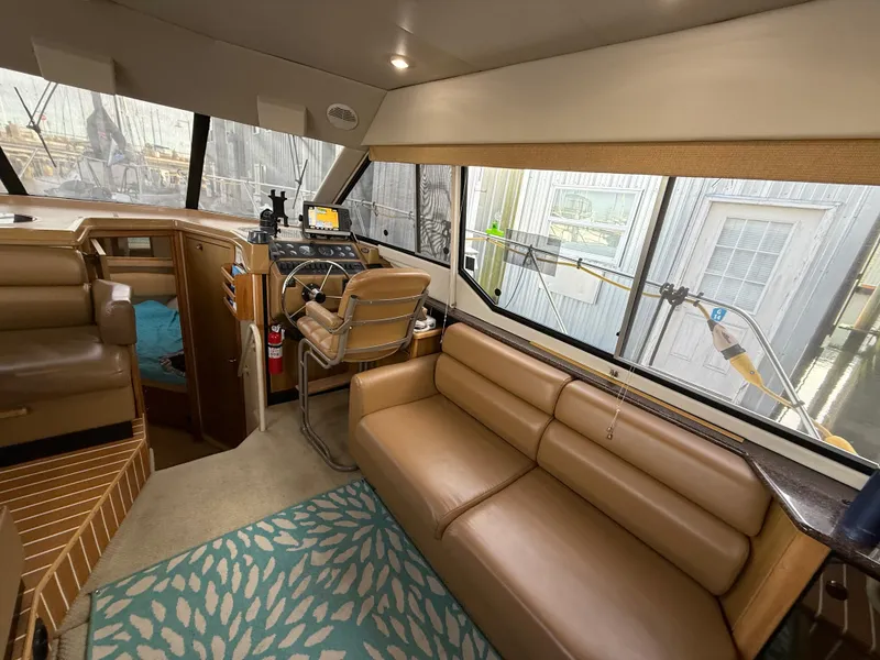 Slide: The Image of Interior of 2002 Bayliner 4087 Aft Cabin Motoryacht with tan seating and nautical decor. - 7