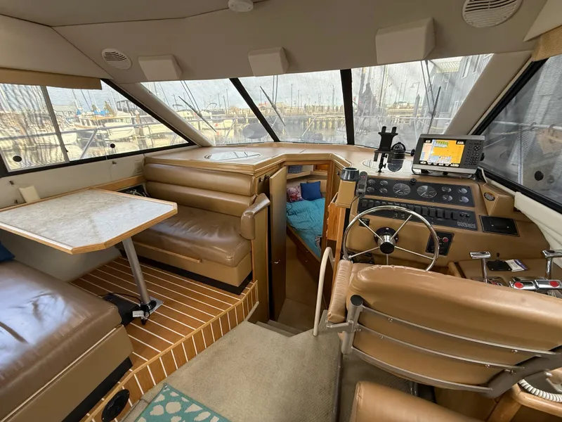 Slide: The Image of 2002 Bayliner 4087 Aft Cabin Motoryacht interior with helm, seating, and navigation equipment. - 8