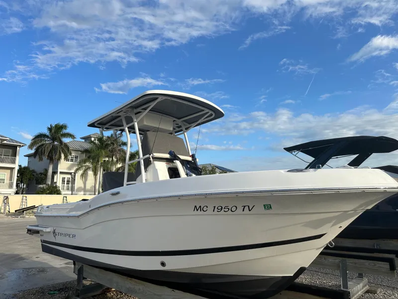 Slide: The Image of 2015 Striper 200 Center Console boat on display under a clear blue sky. - 0