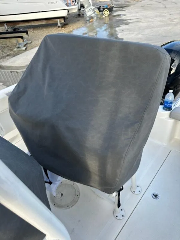 Slide: The Image of 2015 Striper 200 Center Console boat with covered seating area in a marina setting. - 16