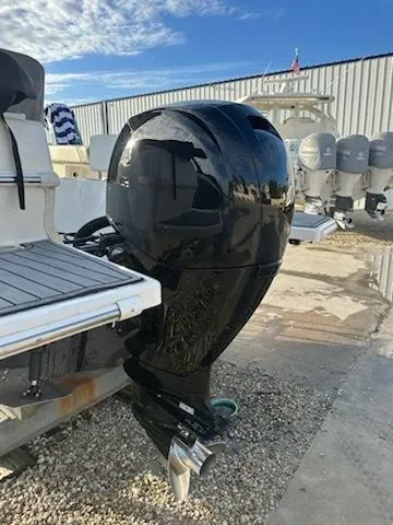 Slide: The Image of 2015 Striper 200 Center Console boat with a powerful outboard motor, parked on gravel. - 18