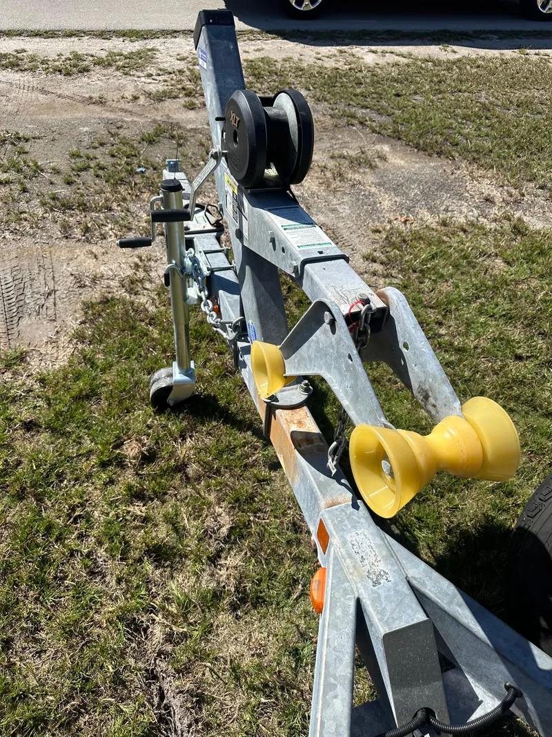 Slide: The Image of Trailer for 2015 Striper 200 Center Console boat on grassy area. - 24